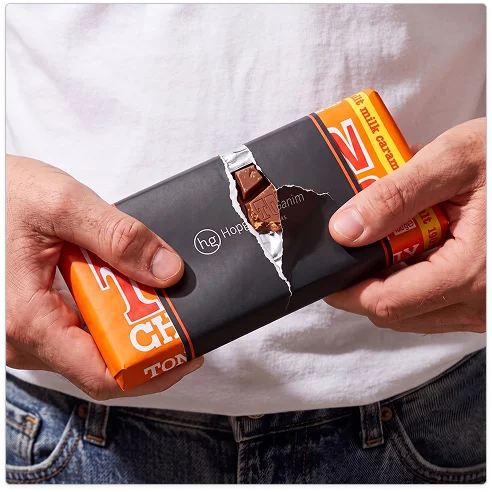 Hands opening a branded chocolate bar