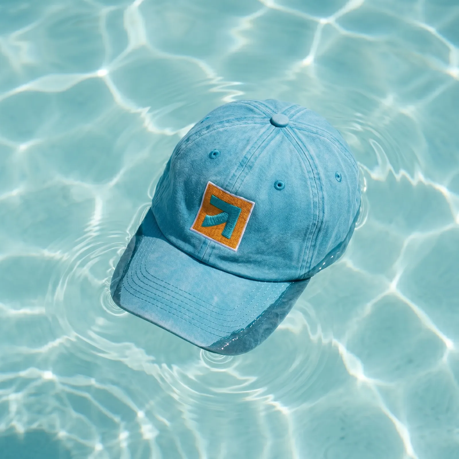 Branded baseball cap floating in a swimming pool